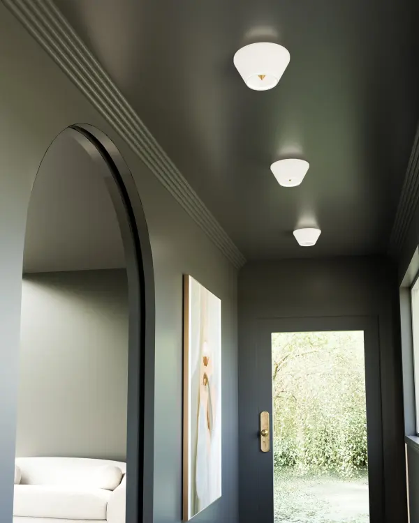 The Holt flush mount combines dramatic spiked pyramid details with warm integrated LED lighting. Its unique geometric design and brushed gold finish create a sophisticated focal point perfect for contemporary spaces. - alternate view