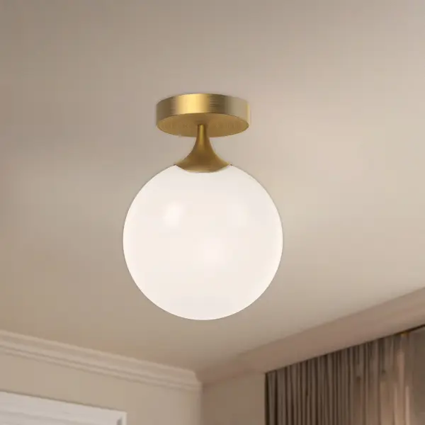 The Nouveau Flush Mount brings 1920s Art Nouveau sophistication to any space with its curved metal detailing and vintage-inspired structure. The aged gold finish paired with opal matte glass creates a warm, inviting glow perfect for intimate spaces. - alternate view