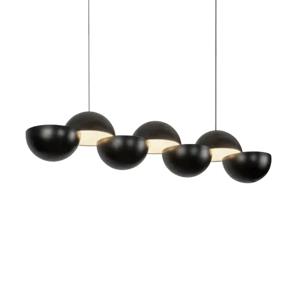 The Void Linear Pendant by Paul Cocksedge Studio transforms lighting into art. Two sculpted metal hemispheres create dramatic interplay between form and light, casting precise shadows while delivering refined LED illumination.