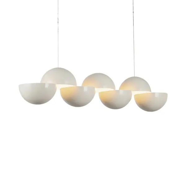The Void Linear Pendant by Paul Cocksedge Studio transforms lighting into art. Two sculpted metal hemispheres create dramatic interplay between form and light, casting precise shadows while delivering refined LED illumination. - alternate view