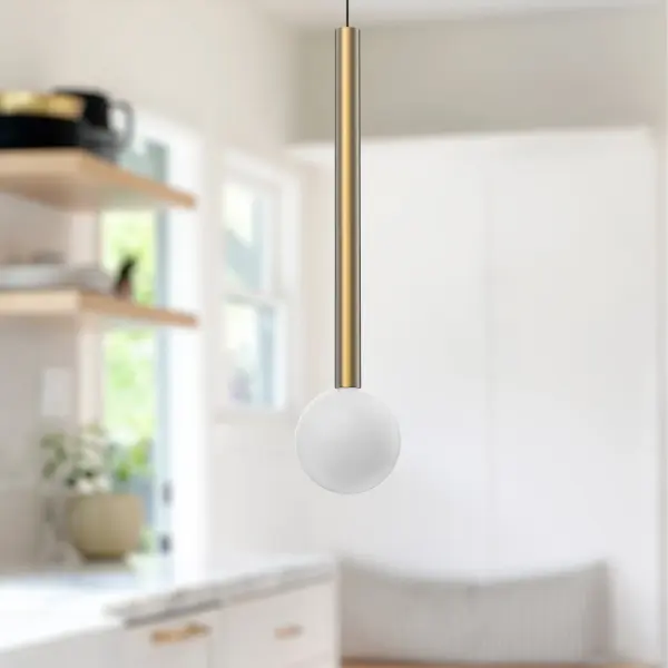 The Elixir pendant combines geometric simplicity with decorative appeal through its opal glass globe and brushed gold metallic stem. Integrated LED with warm 3000K lighting creates inviting ambiance perfect for modern interiors. - alternate view
