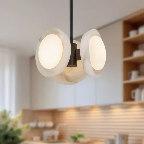 The Alonso pendant masterfully blends traditional craftsmanship with modern sensibility through its carved alabaster shade and forged metal frame. Each piece showcases unique natural veining, making it a distinctive focal point. - alternate view