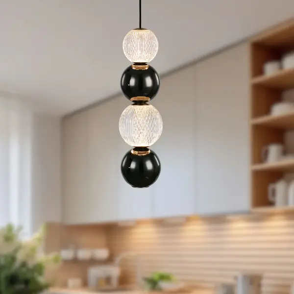 The Onyx pendant brings jewelry-inspired elegance to any space with its meticulously cut spherical glass shade that creates glittering light patterns. The integrated LED and Natural Brass finish combine modern efficiency with timeless style. - alternate view