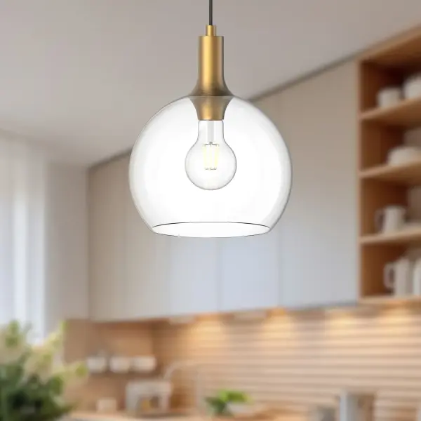 The Castilla pendant combines timeless design with modern versatility. Its aged gold finish and clear glass shade create a sophisticated yet approachable look that transitions seamlessly from fresh farmhouse to eclectic interiors. - alternate view