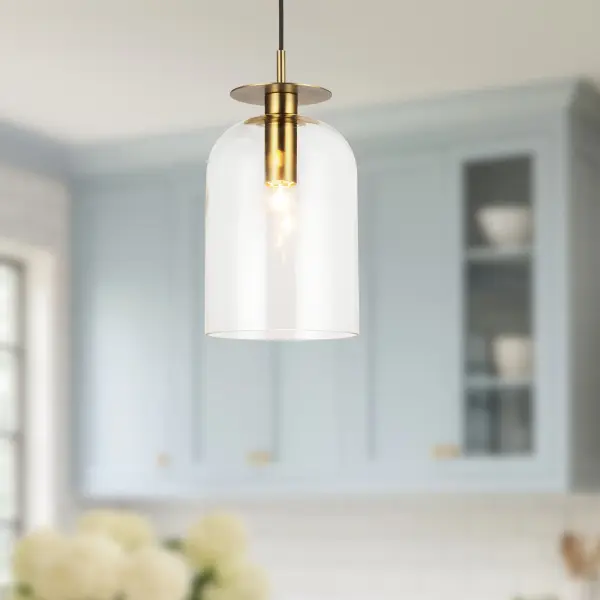 The Sylvia pendant combines sinuous brushed gold metalwork with delicate dome-shaped clear glass for a sophisticated, modern feminine aesthetic. Its compact 8-inch size makes it perfect for multiples over islands or as accent lighting. - alternate view