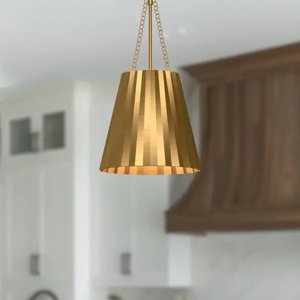The Plisse pendant brings runway-inspired sophistication to your space with its unique pleated metal shade in warm Aged Gold. This 12-inch fixture offers vintage class with modern versatility, perfect for adding chic ambiance to intimate spaces. - alternate view
