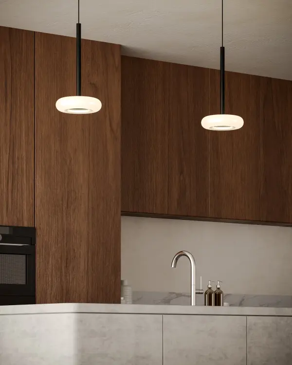 The Stephord pendant combines gracefully curved clear glass with metallic brass accents and integrated 3000K LED lighting. Its compact 4-inch size makes it perfect for multiples over islands or as accent lighting in intimate spaces. - alternate view