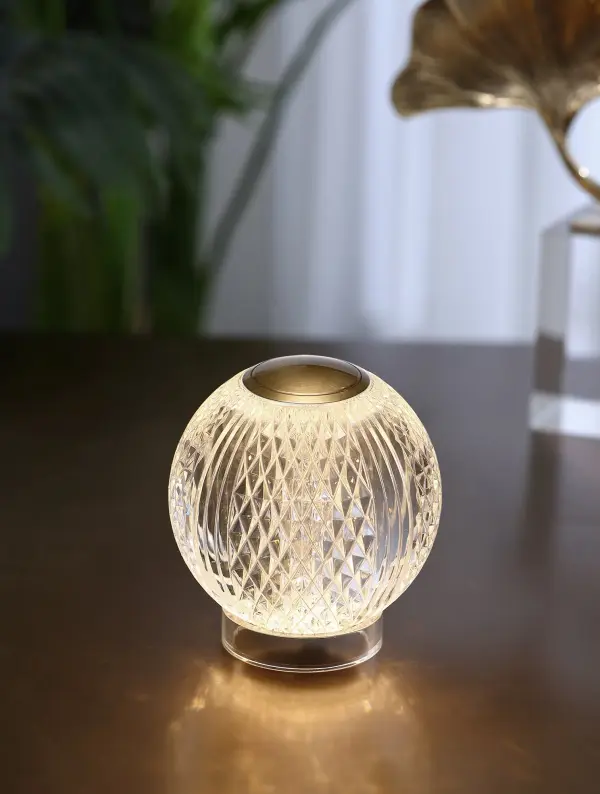 The Marni portable lamp combines sophisticated transitional styling with modern functionality. Featuring integrated LED lighting, rechargeable battery, and intuitive tap dimming, this compact lamp delivers warm ambiance anywhere without cords. - alternate view