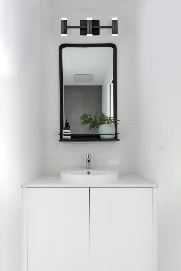 The Brazen vanity light combines contemporary style with functional up-and-down lighting. Its extruded aluminum quatrefoil lamps and opal diffusers create elegant illumination perfect for bathrooms and powder rooms. - alternate view