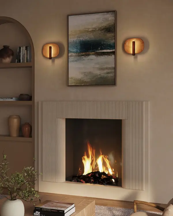 The Lustre Wall Sconce by Branch Creative masterfully blends mid-century modern design with contemporary minimalism. Its candlestick-inspired torchiere creates layered indirect lighting that beautifully illuminates the ceramic-like backplate, delivering both functional illumination and artistic presence. - alternate view