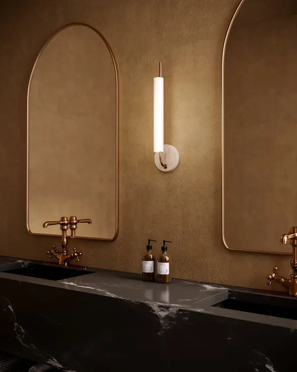 The Wick Wall Sconce reimagines the classic candlestick with a curved metal design and integrated LED lighting. Its opal glass diffuser provides soft ambient illumination while the vintage brass and travertine backplate add warmth and sophistication to any space. - alternate view
