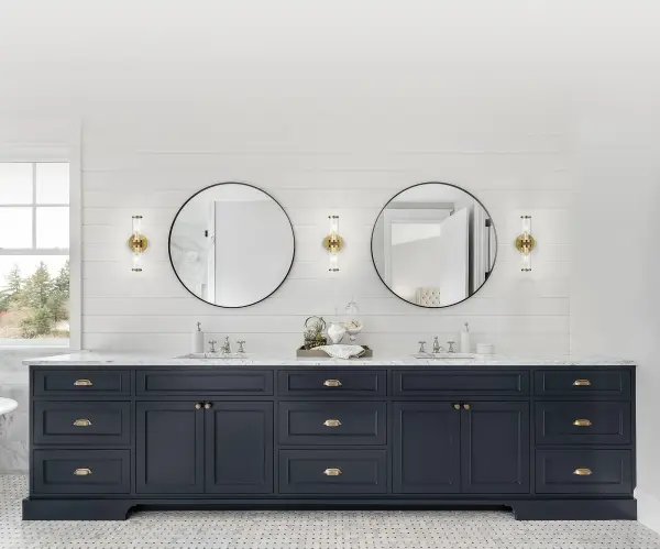 The Revolve vanity light brings timeless elegance to bathroom and powder room spaces with its clear glass tubes and decorative metal rings. The Natural Brass finish adds warmth while the transitional design bridges traditional and contemporary styles. - alternate view