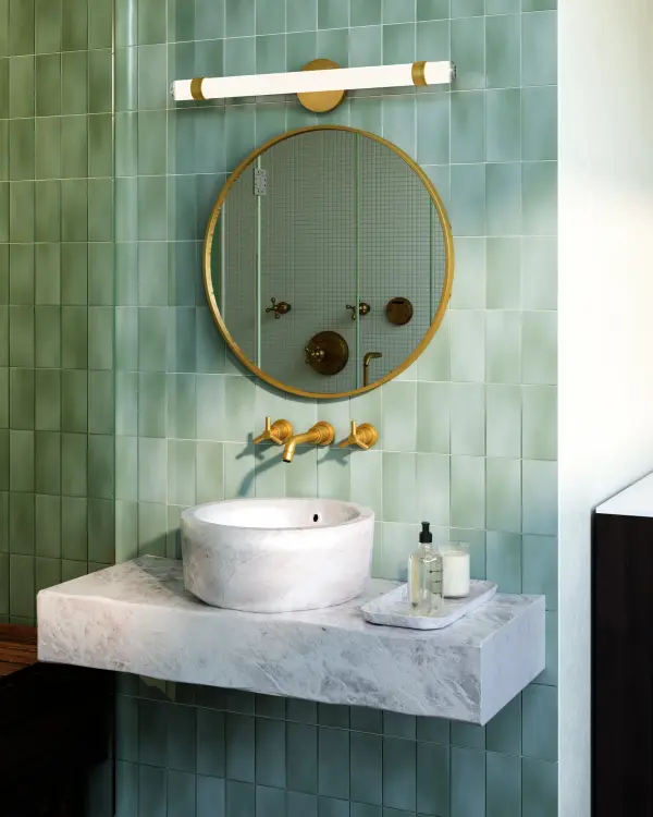 The Madison 30-inch vanity light combines classic elegance with modern functionality. Its large glass tube provides ambient illumination while vintage brass accents add timeless sophistication to any bathroom or powder room. - alternate view
