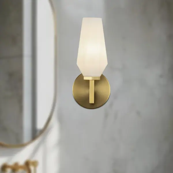 The Krysta vanity light combines clean geometric lines with faceted opal glass that creates stunning light refraction patterns. Its brushed gold finish adds warmth while the sculptural design elevates any bathroom or powder room. - alternate view