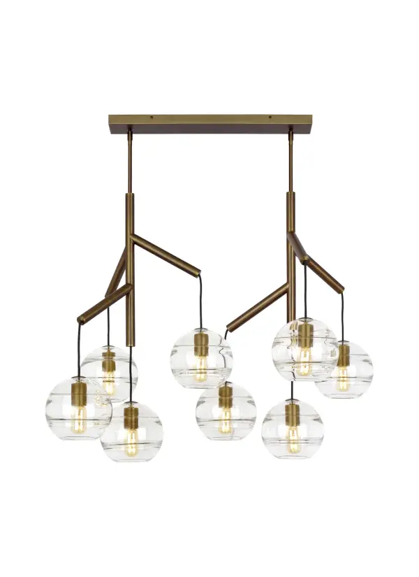 The Sedona chandelier reimagines traditional lighting with eight hand-crafted glass orbs suspended from a sleek brass hub via textured cloth cords. Each transparent orb features artfully thickened interior glass bands that create dimensional visual interest.