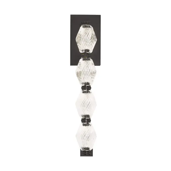 The Collier wall sconce combines Czech crystal craftsmanship with integrated LED technology for a sophisticated lighting statement. Faceted crystal encapsulates LED modules with custom brass connectors, creating dramatic illumination.