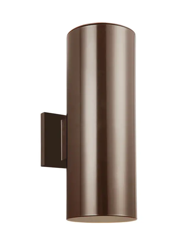 A compact, modern outdoor wall fixture featuring dual cylindrical downlights in durable bronze aluminum. The tempered glass shades and wet-rated construction make it ideal for exposed outdoor locations.