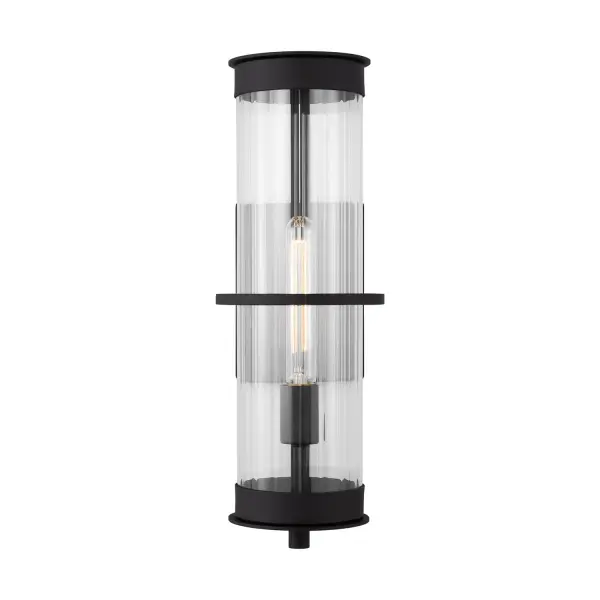 The Alcona wall lantern combines industrial charm with refined elegance through its clear fluted glass and floating effect design. Wet-rated and Title 24 compliant, it delivers both style and safety for exterior applications.
