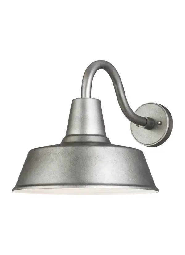 Hand-crafted aluminum wall lantern delivers authentic farmhouse charm with modern LED efficiency. The weathered pewter finish and oversized barn silhouette create bold architectural impact for garages, patios, and commercial entries.