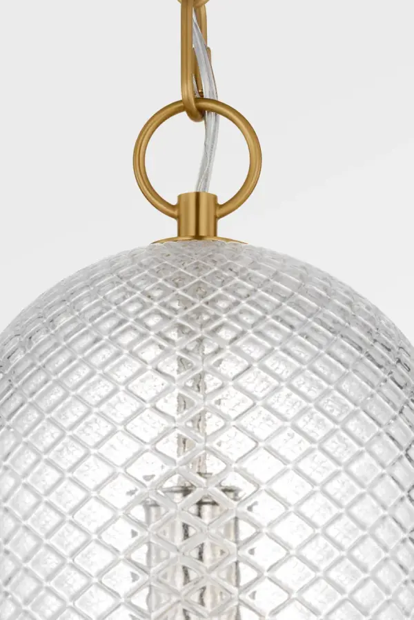 The Lucinda 8" Pendant masterfully blends historical design with modern industrial elegance. Its pill-shaped clear glass and refined brass detailing create a sculptural presence perfect for intimate spaces. - alternate view