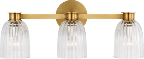 The Asalea Triple Vanity Light combines classic hand-rubbed antique brass with clear glass shades for sophisticated bathroom illumination. Its three-light configuration provides balanced lighting ideal for vanity applications.