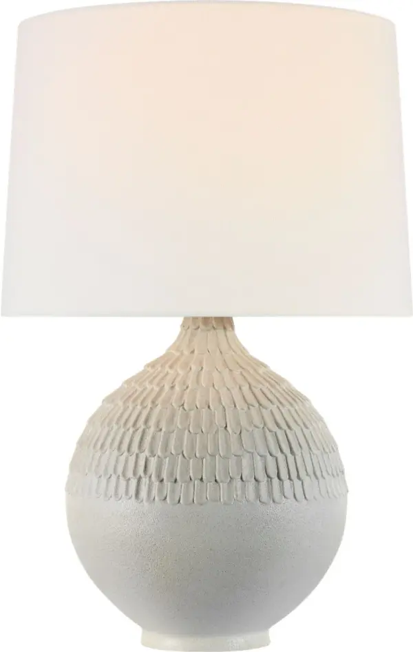 The Morava table lamp showcases exceptional hand-carved craftsmanship in a striking volcanic white finish. Its organic texture and sculptural base create visual interest while the linen shade provides warm, diffused light.