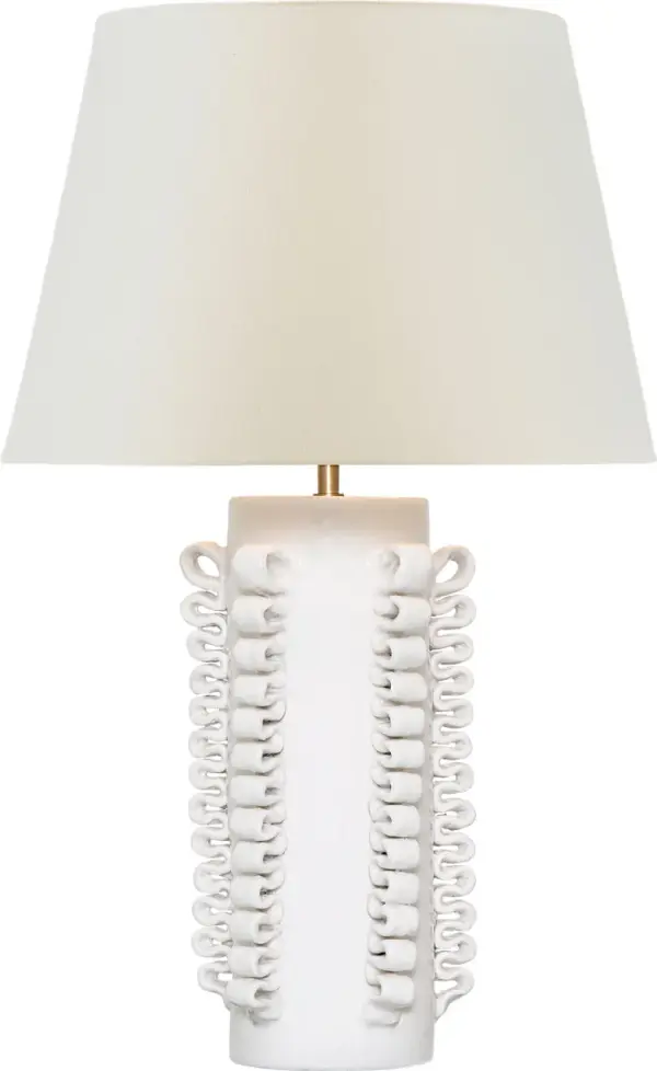 The Amandine table lamp features a distinctive glossy white crackle ceramic base paired with a classic linen shade. At 25" tall, it provides substantial presence while maintaining versatility across traditional and contemporary interiors.