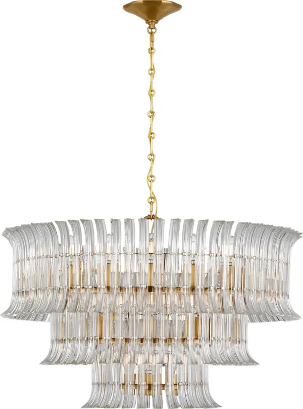 The Rhine chandelier delivers grand-scale luxury with its impressive 34-inch diameter and three-tier crystal design. Hand-rubbed antique brass finish adds warmth and sophistication, making it a statement piece for formal spaces.