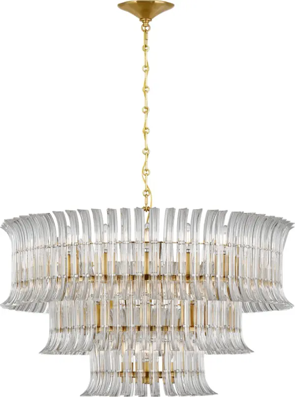 The Rhine chandelier delivers grand-scale luxury with its impressive 34-inch diameter and three-tier crystal design. Hand-rubbed antique brass finish adds warmth and sophistication, making it a statement piece for formal spaces. - alternate view