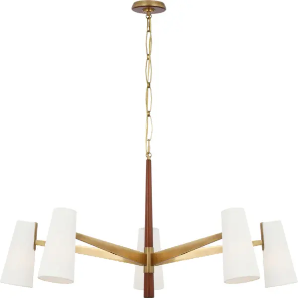 The Olina chandelier combines hand-rubbed antique brass with rich mahogany wood details and soft linen shades, creating a refined statement piece that bridges traditional elegance and organic modern sensibility.