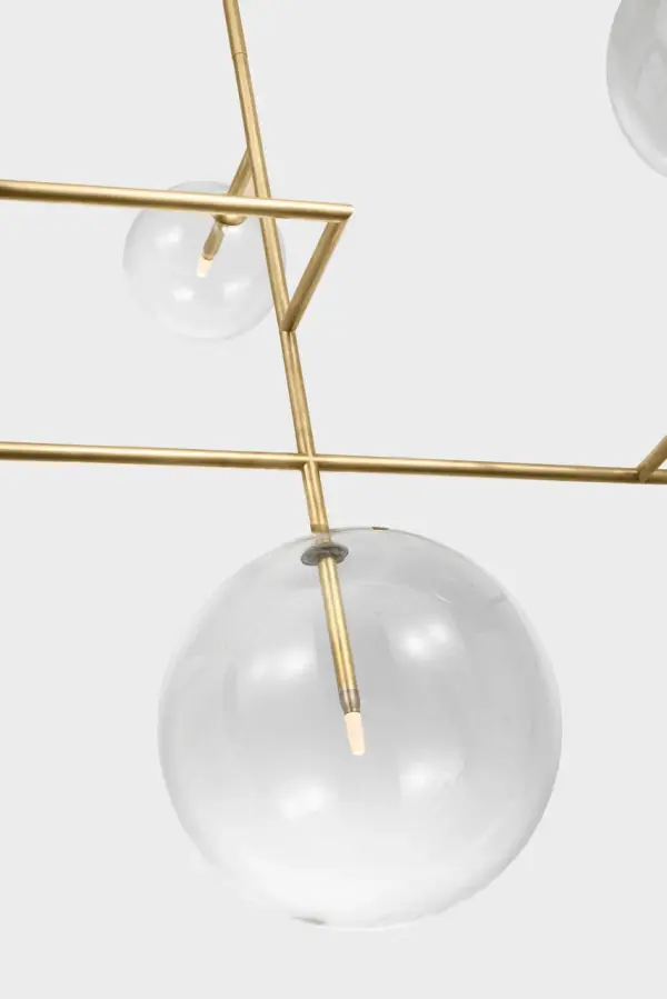 The Linnea 59" chandelier commands attention with its impressive scale and sophisticated design. Hand-rubbed antique brass paired with clear glass creates a refined aesthetic that bridges traditional and contemporary styles. - alternate view