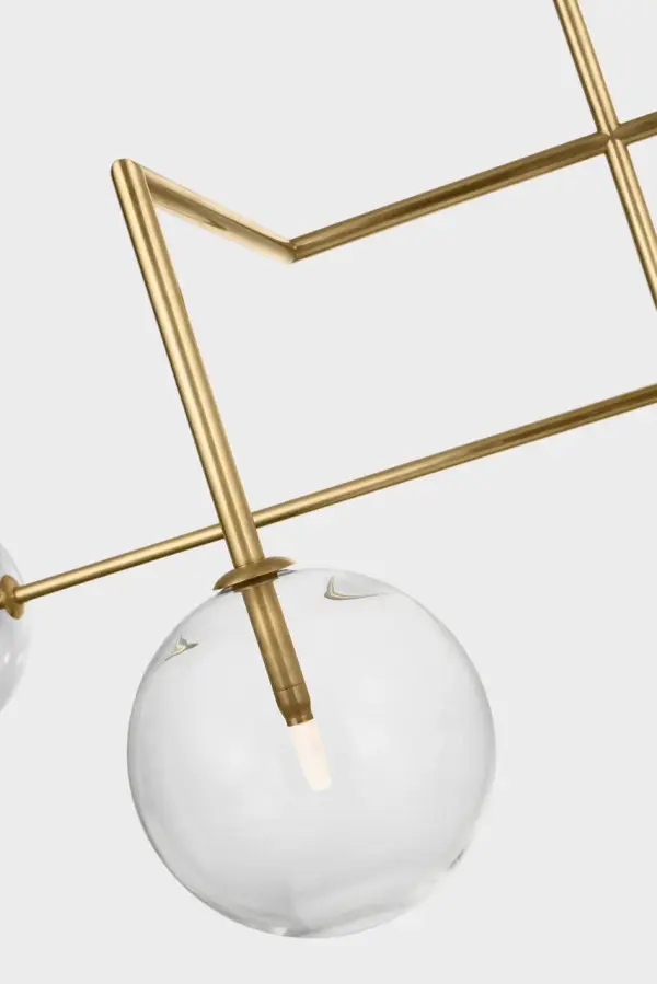 The Linnea chandelier makes a bold statement with its impressive 57-inch length and hand-rubbed antique brass finish. Clear glass shades provide brilliant illumination while the warm brass tones add timeless elegance to any space. - alternate view