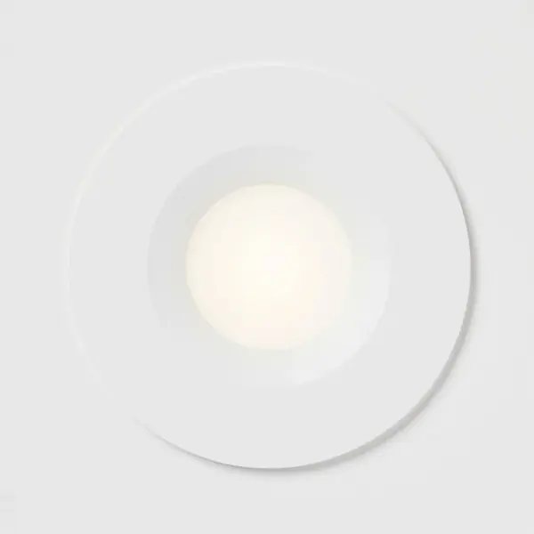 The Avara 4" LED downlight delivers refined, architectural lighting with its deeply regressed design that minimizes glare. Perfect for modern spaces requiring clean, ambient illumination with a 3000K warm white temperature. - alternate view