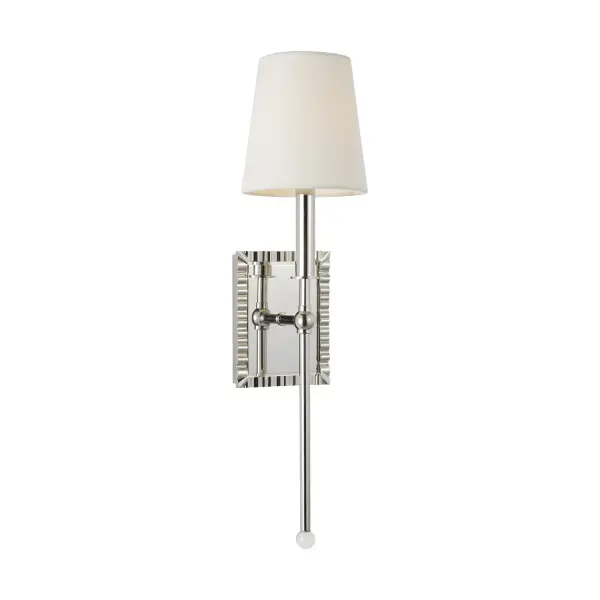 The Baxley wall sconce by Alexa Hampton blends traditional elegance with modern sophistication. Its exaggerated stem topped with a crystal ball creates a bold statement, while the white linen shade softens the look.