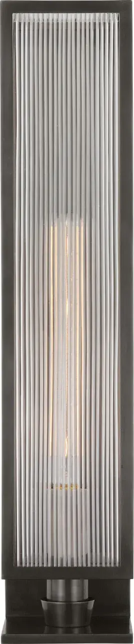 The York sconce combines traditional craftsmanship with versatile styling. Its substantial 24-inch size and clear ribbed glass create beautiful light diffusion, while the bronze finish adds warmth to any space. - alternate view