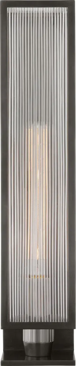 The York outdoor sconce combines classic design with durable construction. Its substantial 24-inch height and clear ribbed glass create beautiful light patterns while the bronze finish adds warmth to any exterior space.