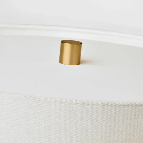 The Roma Table Lamp by Barbara Barry combines refined design with artisanal craftsmanship. Its elongated oval ceramic base features a distinctive deep ocean crackle finish, while the tailored linen shade provides warm, diffused illumination perfect for both modern and traditional spaces. - alternate view