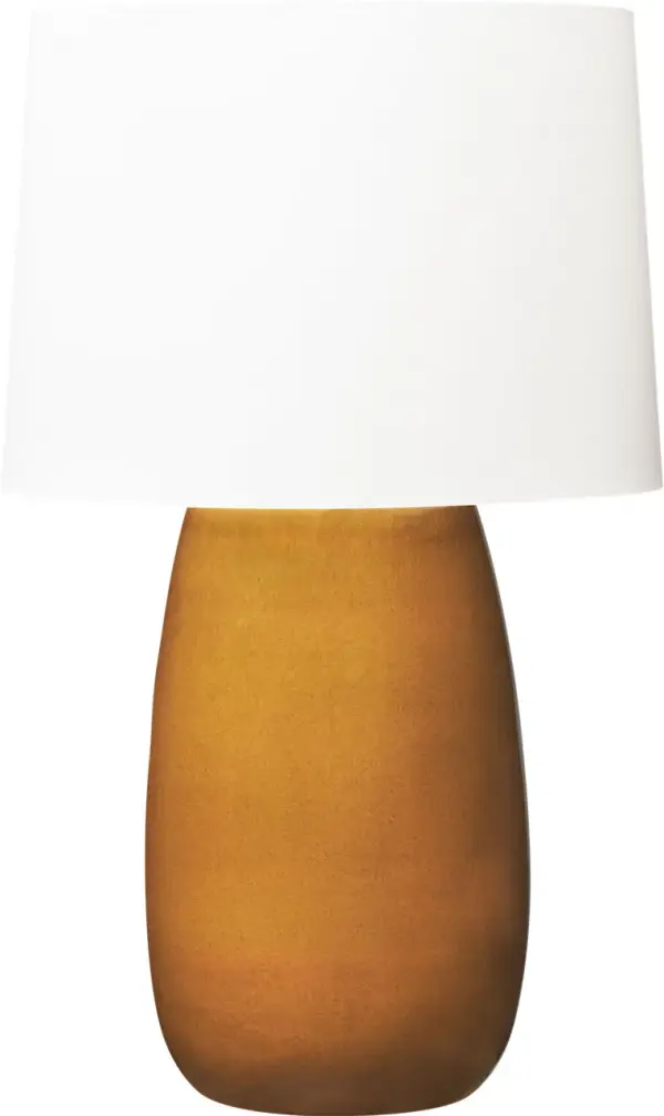 The Roma Table Lamp by Barbara Barry combines timeless elegance with modern sensibility. Its elongated oval ceramic base in sophisticated olive finish pairs beautifully with a tailored linen shade for warm, diffused lighting.