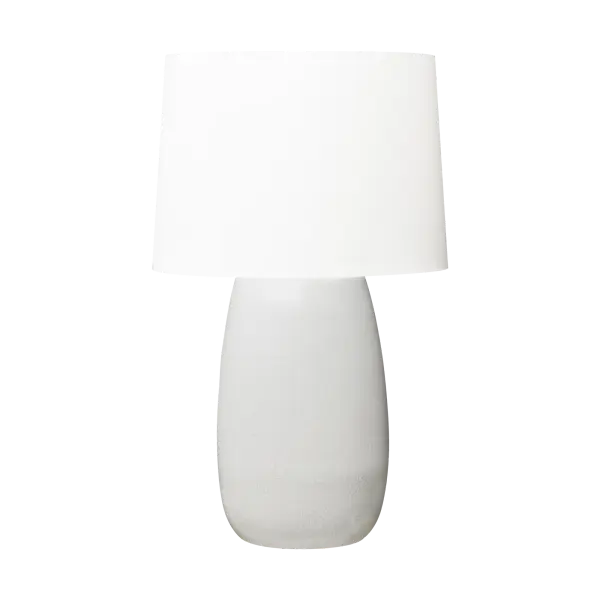 Barbara Barry's Roma Table Lamp combines an elegant elongated oval ceramic base with a tailored linen shade, creating a refined lighting solution that bridges modern and traditional aesthetics with timeless appeal.