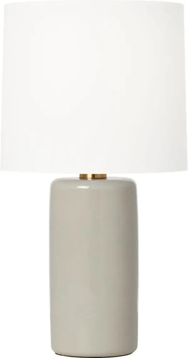 The Shanghai Table Lamp by Barbara Barry combines a sleek cylindrical ceramic base with a tailored linen drum shade, creating an understated yet refined lighting solution perfect for modern and transitional spaces.