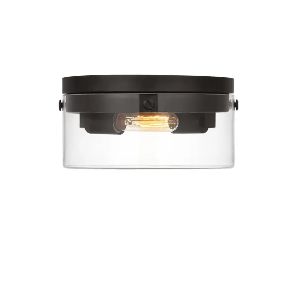 The Garrett flush mount by Chapman & Myers combines industrial hardware with clear extruded glass cylinders for a sophisticated yet simple aesthetic. Its compact 11.38-inch profile and aged iron finish make it versatile for various spaces.