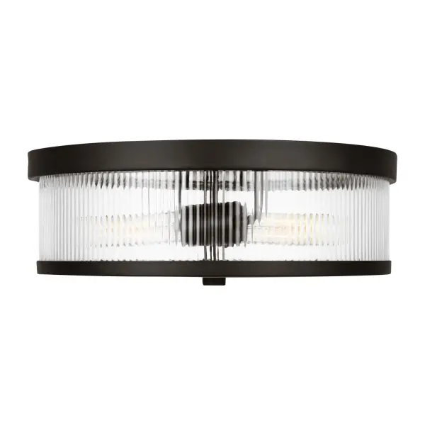 The Geneva flush mount by Chapman & Myers combines refined fluted glass with an industrial-inspired aged iron frame. Its low-profile design and damp rating make it ideal for compact spaces needing both style and function.