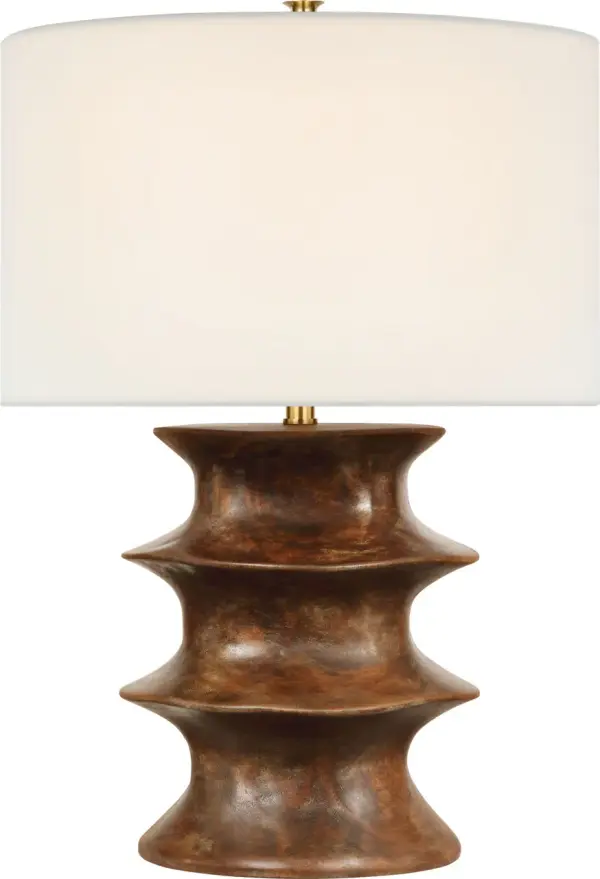 The Eldin table lamp combines a rich smoked umber finish with a classic linen shade, creating a versatile lighting solution that bridges traditional and contemporary design. At 28" tall, it provides substantial presence without overwhelming spaces.