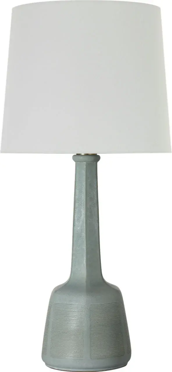 The Lerio table lamp brings refined coastal elegance with its distinctive dusted jade ceramic base and classic linen shade. At 31" tall, it provides substantial presence while maintaining versatility across traditional and contemporary interiors.