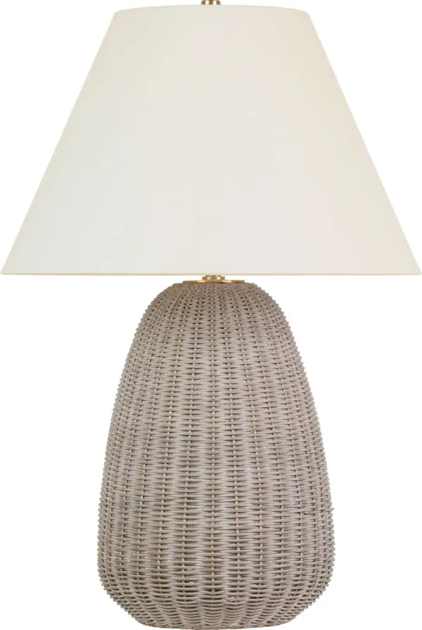 The Kokomo table lamp brings organic warmth through handcrafted ash wicker paired with antique-burnished brass details. At 30" tall, it provides substantial presence while maintaining versatility across coastal, transitional, and organic modern interiors.
