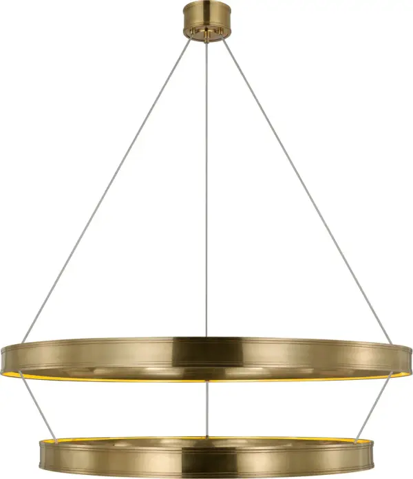 The Connery 50" chandelier commands attention with its dramatic two-tier ring construction and warm antique-burnished brass finish. This oversized fixture brings architectural sophistication to grand spaces.