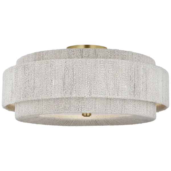 The Dorado 25" flush mount combines warm antique brass with natural woven abaca for a sophisticated coastal aesthetic. Its generous 25-inch diameter makes a bold statement while maintaining a low profile perfect for standard ceiling heights. - alternate view