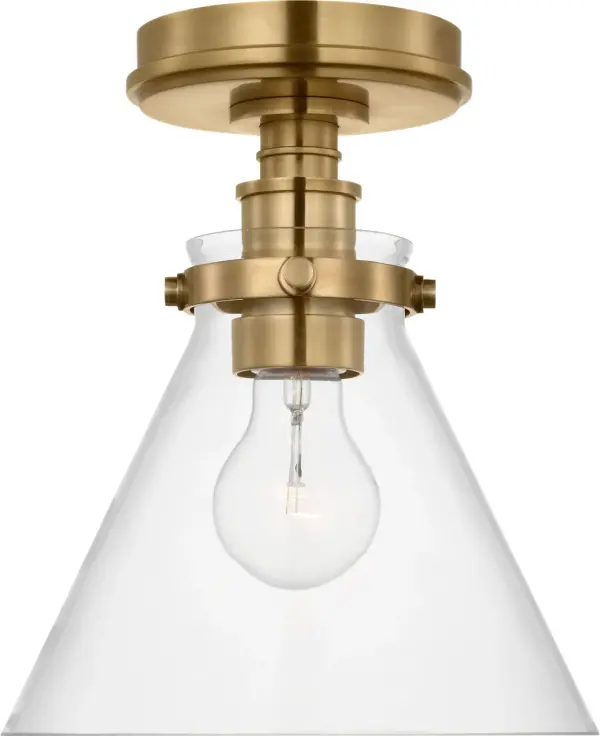 The Parkington 9" flush mount combines classic brass warmth with clean conical glass for versatile lighting. Its compact profile suits smaller spaces while the antique-burnished finish adds sophisticated character.