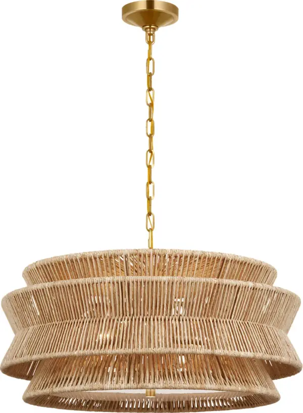 The Antigua chandelier brings warmth and natural beauty with its handwoven abaca shade and antique brass finish. At 30 inches wide, it makes a sophisticated statement while maintaining an airy, organic feel perfect for coastal and transitional interiors.