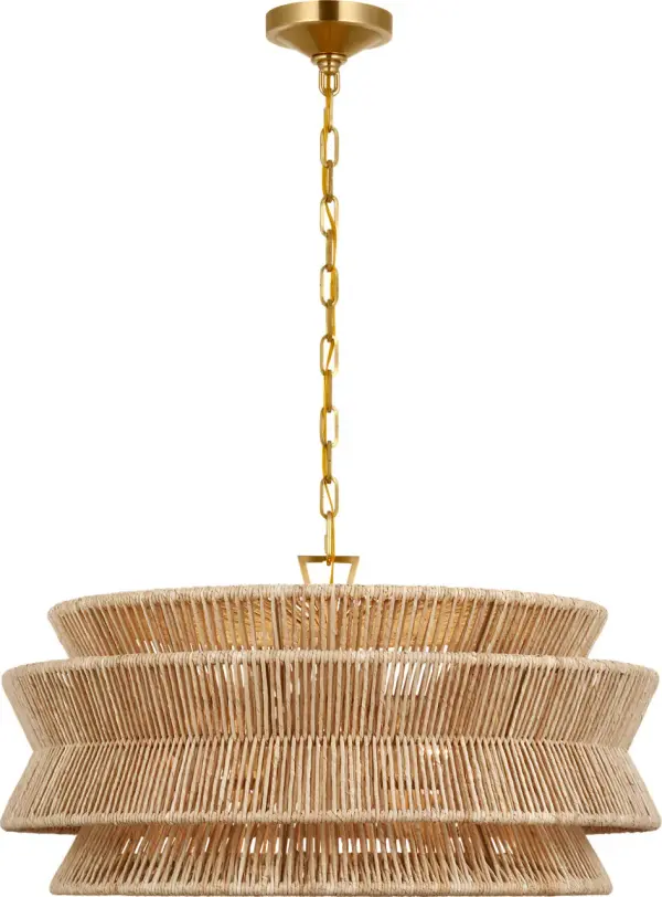 The Antigua chandelier brings warmth and natural beauty with its handwoven abaca shade and antique brass finish. At 30 inches wide, it makes a sophisticated statement while maintaining an airy, organic feel perfect for coastal and transitional interiors. - alternate view